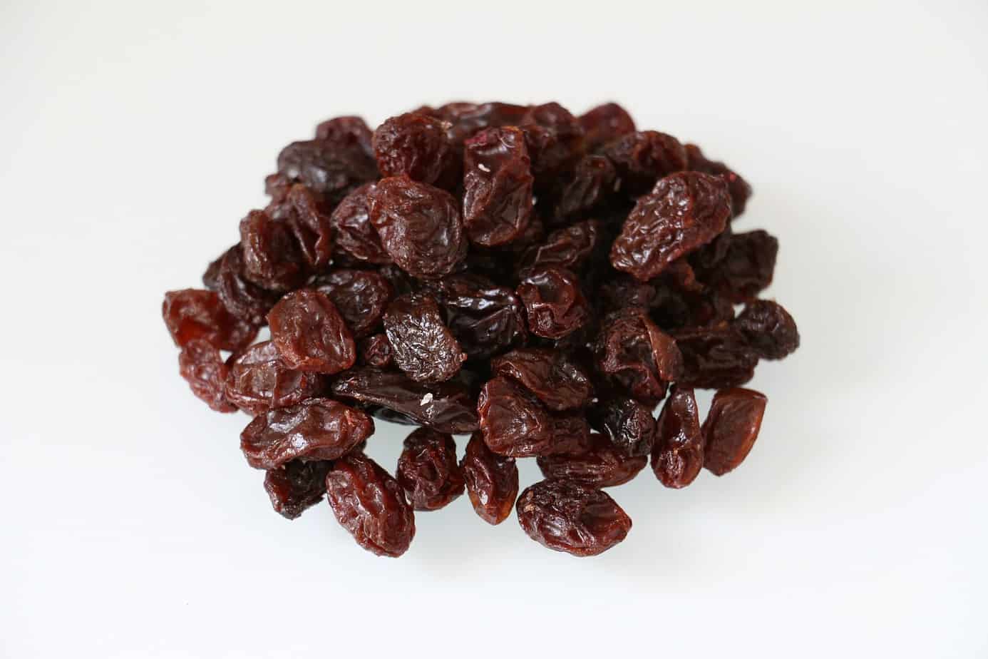 plain raisins on a white background