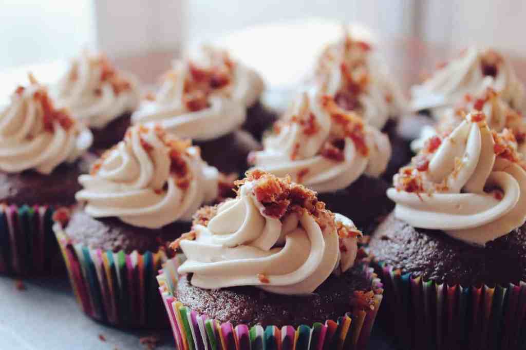 Chocolate cupcakes with piped vanilla frosting. 